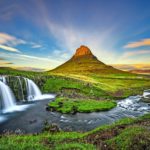 Summer sunset over the famous Kirkjufellsfoss Waterfall with Kirkjufell mountain in the background in Iceland. Long exposure.